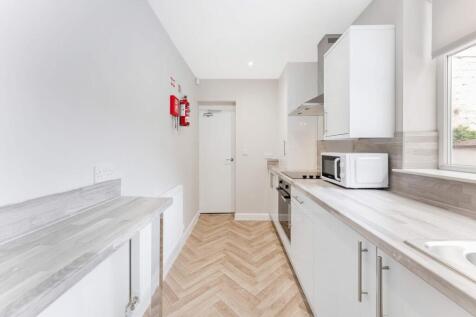 Modern kitchen with sleek cabinetry and ample c...
