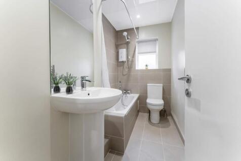 A modern bathroom featuring a clean design with...