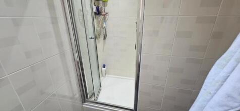 This well-maintained bathroom features a modern...