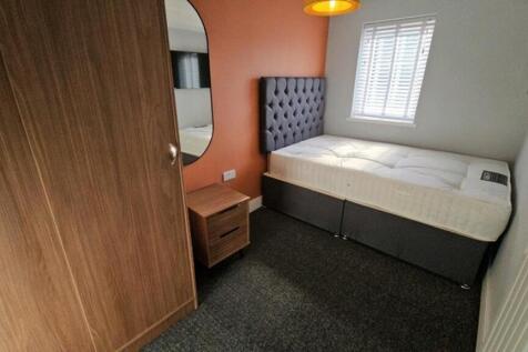 This cozy double bedroom features a comfortable...