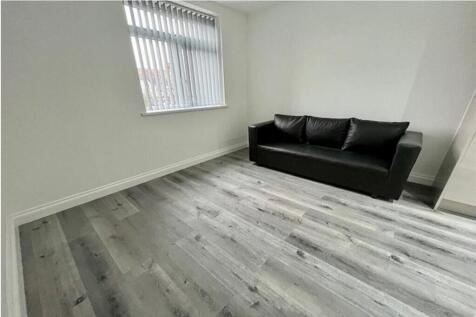Bright and modern living room featuring a comfo...