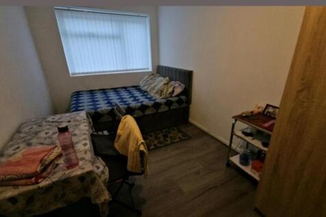 This cozy double bedroom features a comfortable...