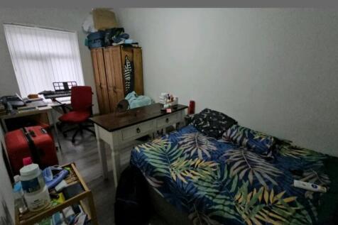 A cozy double bedroom featuring a vibrant tropi...