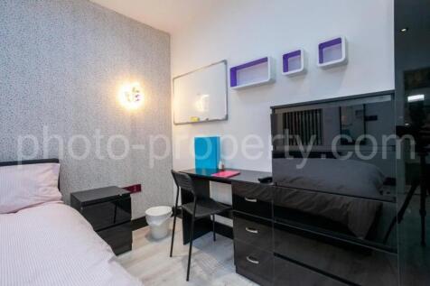 This stylish double bedroom features modern fur...