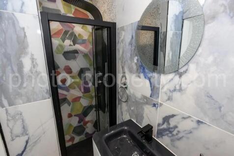 A beautifully designed bathroom featuring styli...