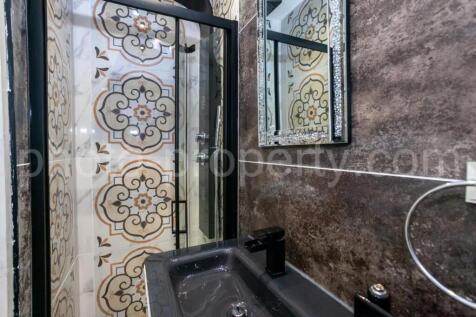 This stylish bathroom features a modern design ...