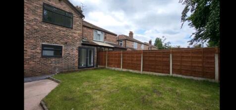 A spacious and well-maintained garden area feat...