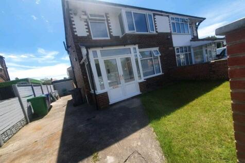 Bright front view of a semi-detached house with...