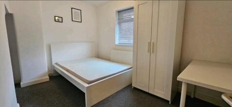 A neat and bright double bedroom featuring a wh...