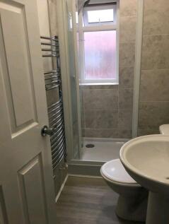 A clean and modern bathroom featuring a shower ...