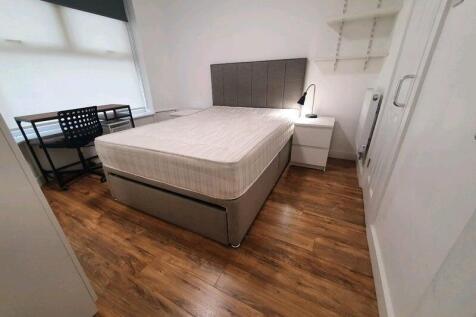 A bright and tidy double bedroom featuring a co...