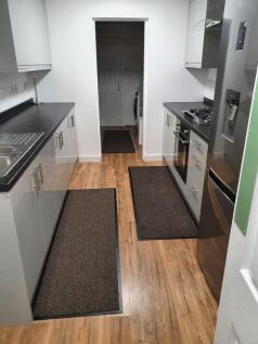 Modern galley kitchen with sleek grey cabinetry...