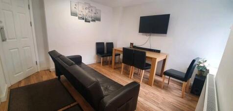 A bright and tidy communal lounge featuring a s...