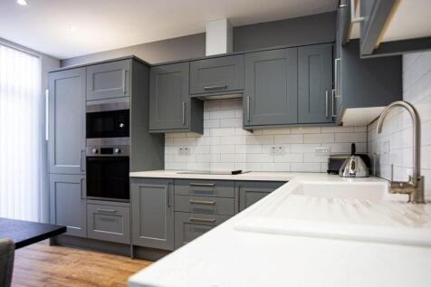 Contemporary kitchen featuring sleek grey cabin...