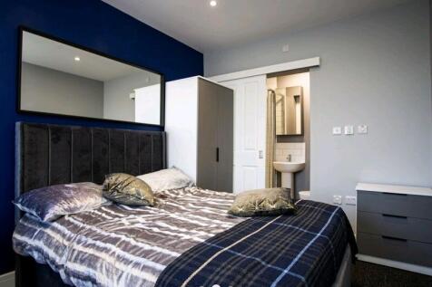 A stylish double bedroom featuring a comfortabl...