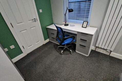 A neat and modern communal workspace featuring ...