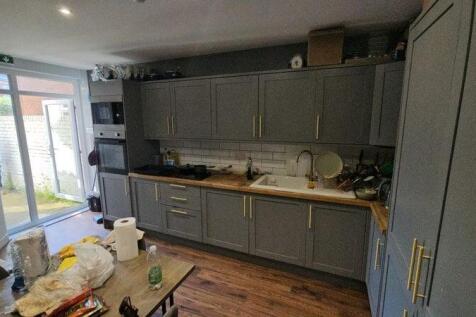 Modern kitchen featuring stylish grey cabinetry...