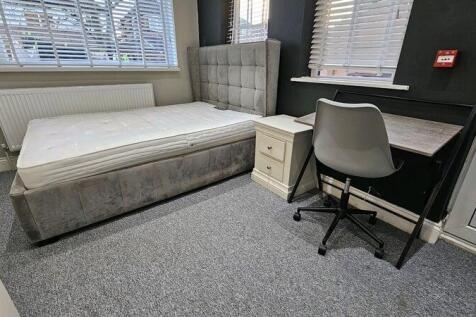 A neat and modern double bedroom featuring a pl...