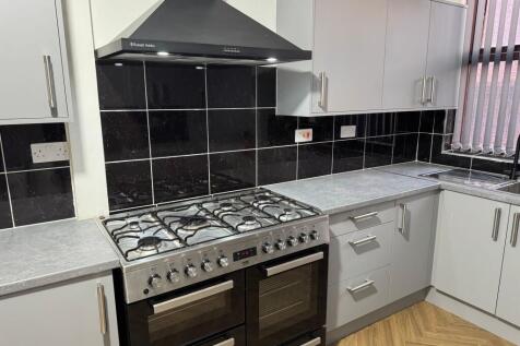 Modern kitchen featuring a large stainless stee...