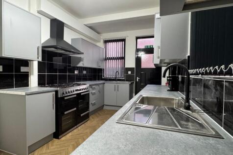 Bright and modern kitchen featuring sleek grey ...