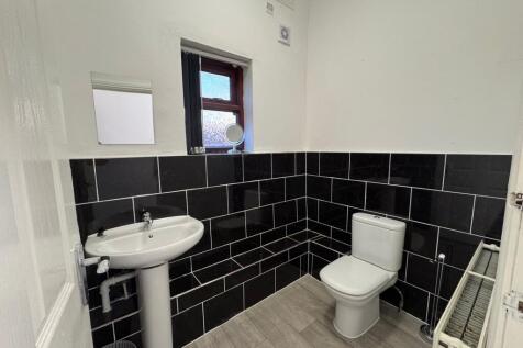 Bright and modern bathroom featuring stylish bl...