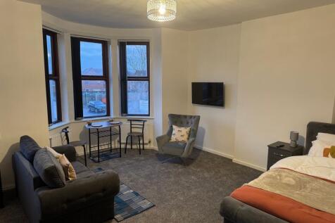 A spacious and inviting master bedroom featurin...