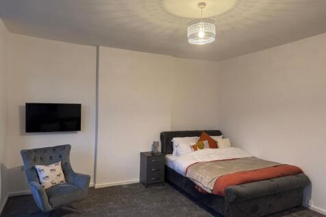 A cozy double bedroom featuring a plush dark up...