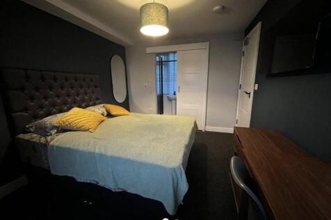 A cozy and well-maintained master bedroom featu...