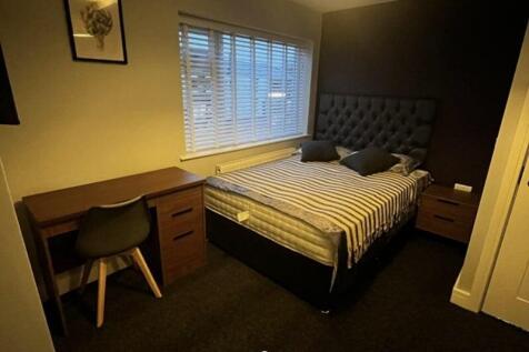Cozy double bedroom featuring a comfortable bed...