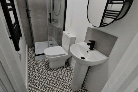 A modern bathroom featuring a stylish patterned...