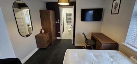 A modern double bedroom featuring a comfortable...