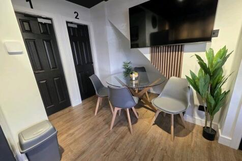 Modern communal workspace featuring a sleek gla...