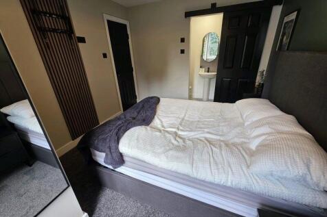 A stylish double bedroom featuring a comfortabl...