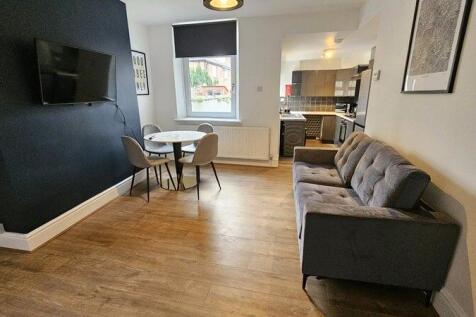 Bright and modern living room featuring a comfo...
