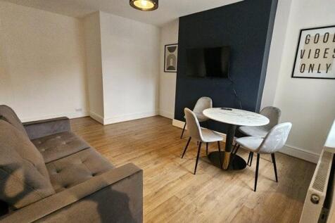 A modern living room featuring a comfortable gr...