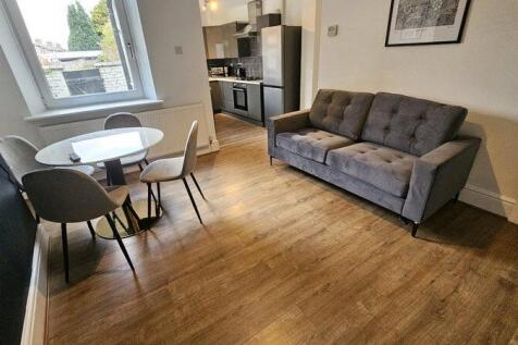 Modern living room featuring a comfortable grey...