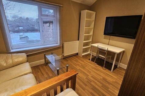 A cozy living room featuring a comfortable crea...
