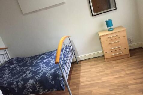 A tidy single bedroom featuring a neat metal-fr...