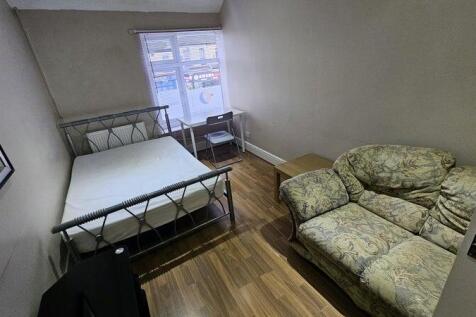 A cozy double bedroom featuring a double metal-...