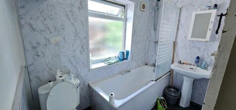 Well-lit bathroom suite featuring a full-size b...