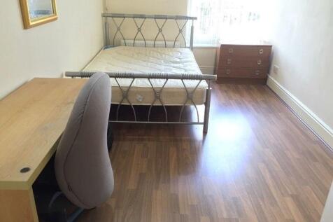 A neat and bright single bedroom featuring wood...