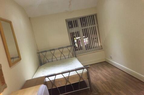 A minimalistic single bedroom featuring a metal...