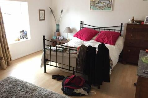 Bright and cozy master bedroom featuring a stur...
