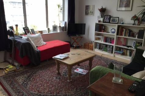 A cozy and inviting living room featuring a pat...