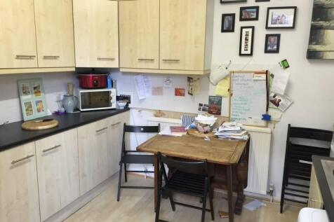Bright kitchen area featuring ample light wood ...