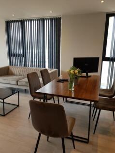Contemporary living room featuring a wooden din...