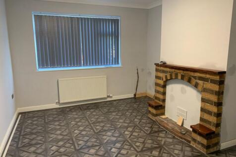 A clean and tidy living room featuring a decora...
