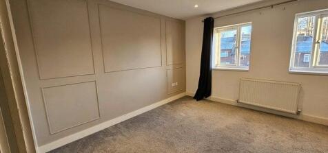 A bright and clean double bedroom featuring two...