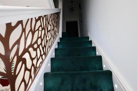 A clean and well-maintained staircase featuring...