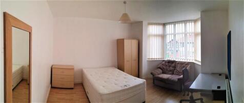 A bright and tidy single bedroom featuring a la...
